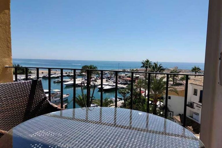 view of cabopino harbour from the terrace of the apartment on a sunny day